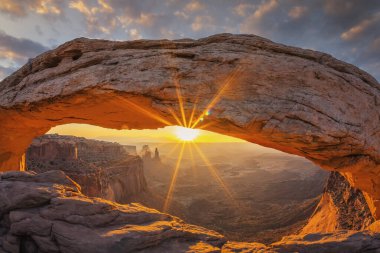 Famous sunrise at Mesa Arch in Canyonlands National Park near Moab, Utah, USA  clipart