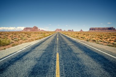 Desert highway leading into Monument Valley clipart