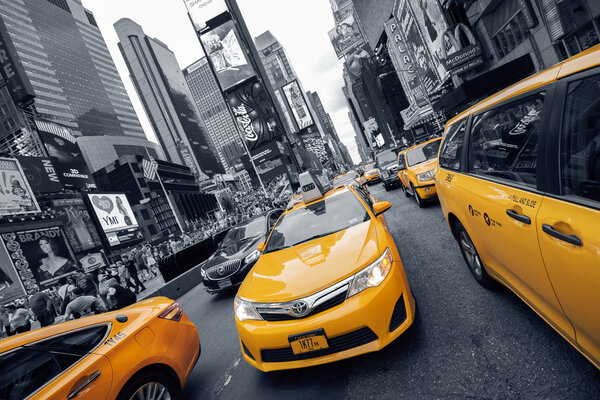 NEW YORK CITY, NY - JULY 9: Yellow Cab at Times Square on July 9, 2015 in New York City, NY. It is one of the world's busiest intersections and is the world's most visited tourist attraction.