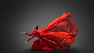 Woman in red dress with flying fabric