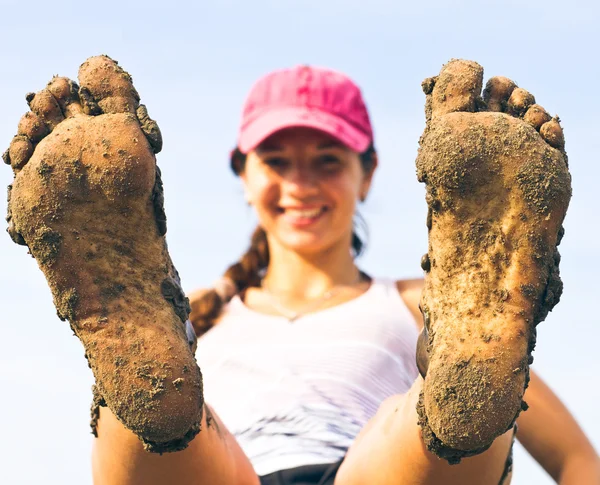 Chica acostada en la hierba sus pies sucios . Fotos de stock libres de derechos