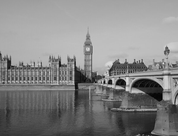 LONDON, UK - SEPTEMBER 28, 2015: Tourists on Westminster Bridge at the Houses of Parliament aka Westminster Palace in black and white