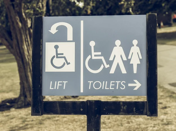 Vintage looking Lift and toilets sign — Stock Photo, Image