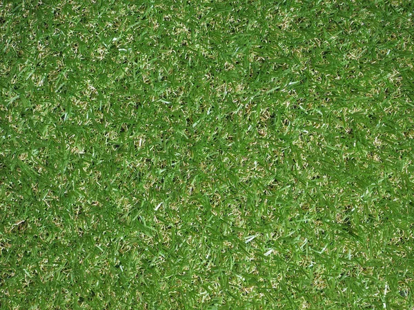 Green artificial synthetic grass meadow background — Stock Photo, Image