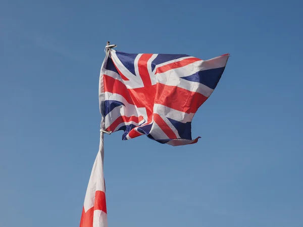 Flag of UK over blue sky — Stok fotoğraf