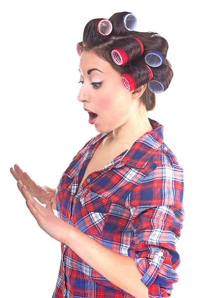 Woman with hair rollers looking in studio — Stock Photo, Image