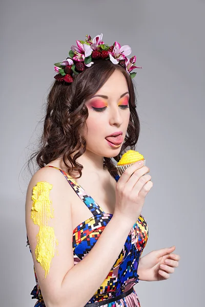 Sexy blonde woman tasting cream of muffin — Stock Photo, Image