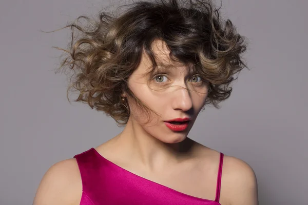 Air hairstyle cute girl. Photo taken in the studio on a gray background — Stock Photo, Image