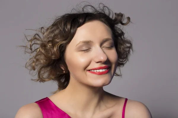 Overhead hairstyle cute girl. Photo taken in the studio on a gray background — Stock Photo, Image