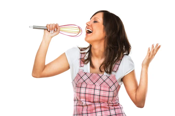 Young woman singing with egg beater — Stock Photo, Image