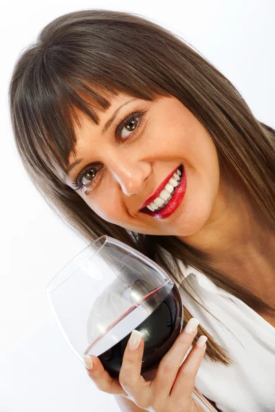 Mujer joven bebiendo vino tinto Imagen de archivo