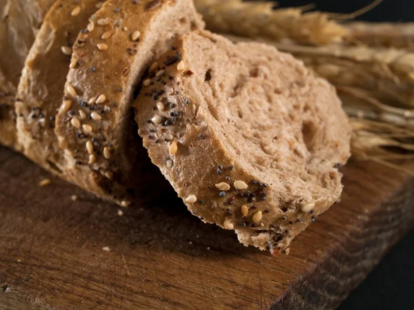 Homemade bread with raw wheat — Stock Photo, Image