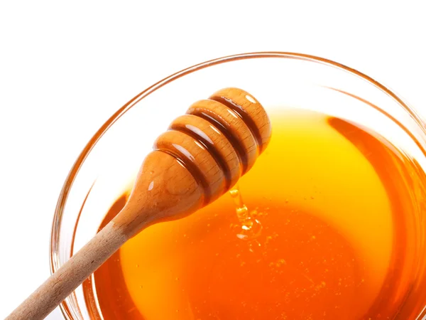 Honung i skål och trä strömstare — Stockfoto