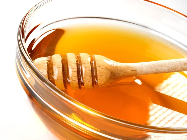Honey in bowl with dipper Stock Photo