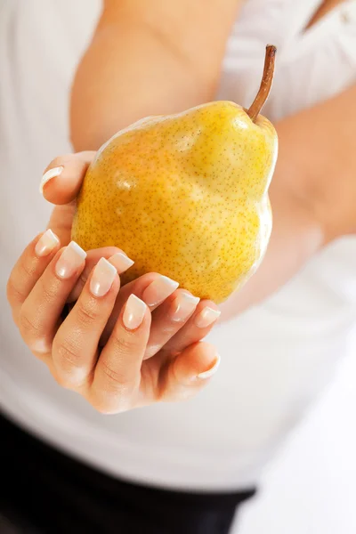 Young woman holding pear — Stock Photo, Image