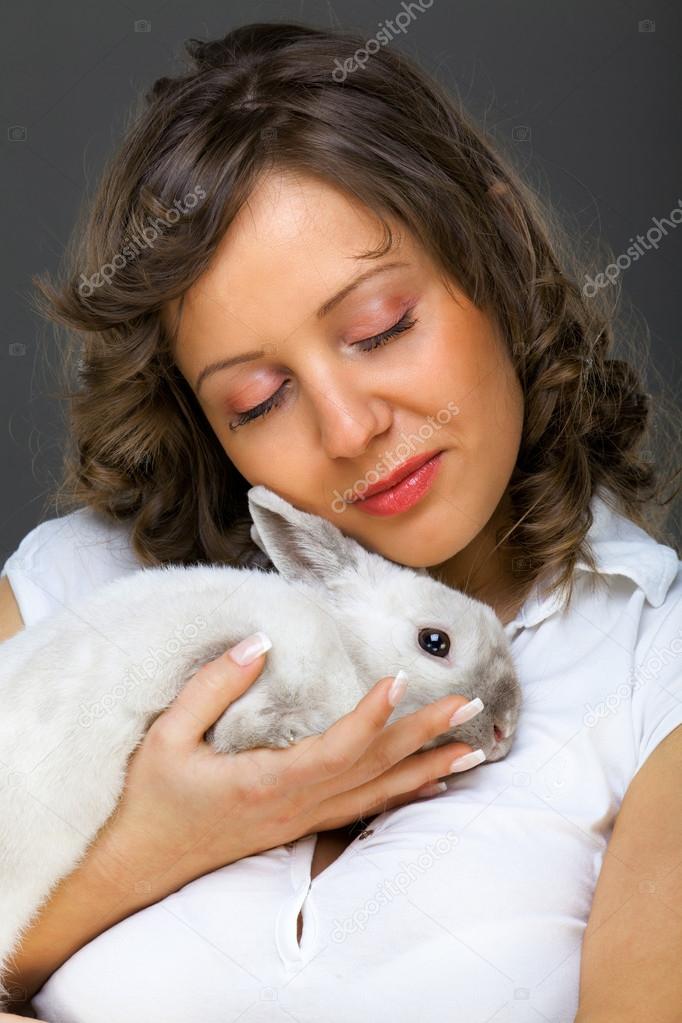 Young woman hugging rabbit Stock Photo by ©ivanmateev 62147995