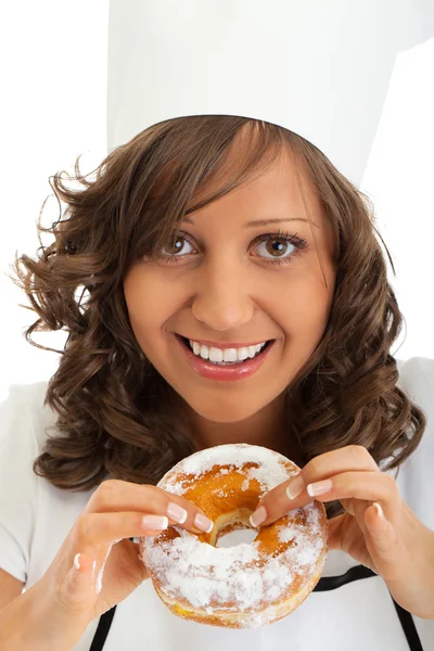 Woman Chef eating donut — Stock Photo, Image