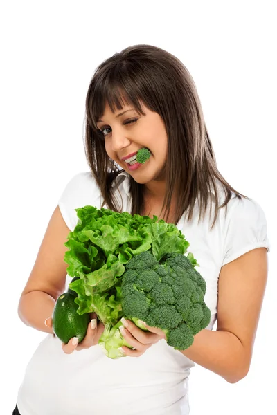 Jovem mulher comendo brócolis — Fotografia de Stock