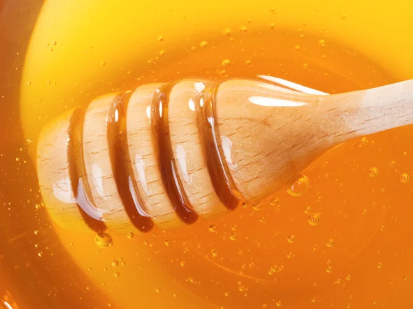 Honey with wooden dipper — Stock Photo, Image