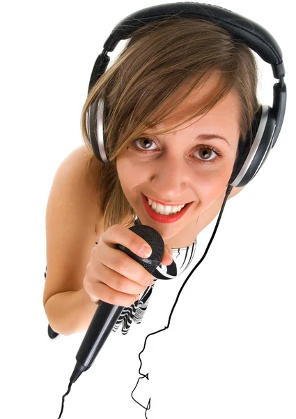 Woman singing into microphone — Stock Photo, Image