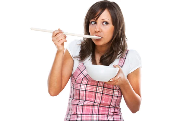 Young woman tasting food — Stock Photo, Image