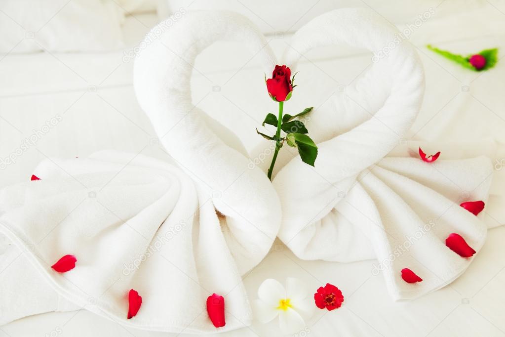 Towel swan heart on bed