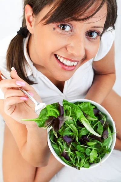 Jovem mulher comendo salada — Fotografia de Stock