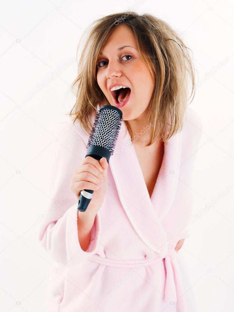 Woman singing with hairbrush