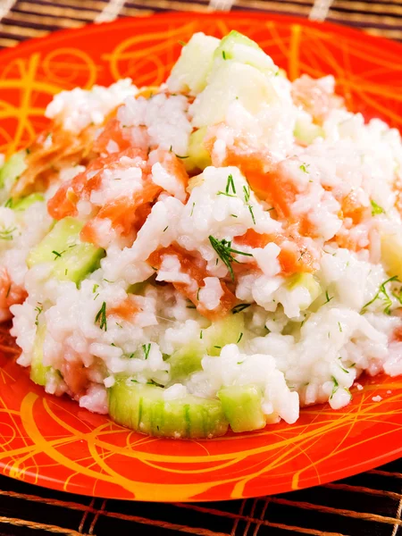 Rice with salmon and cucumbers — Stock Photo, Image
