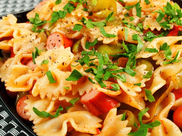 Farfalle with sausage and parsley — Stock Photo, Image