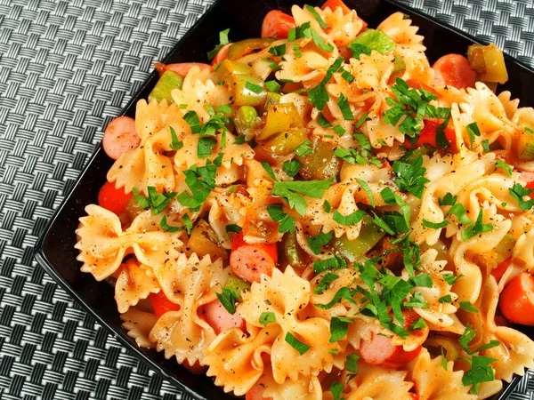 Farfalle with sausage and parsley — Stock Photo, Image