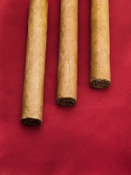 Three Cigars on red — Stock Photo, Image