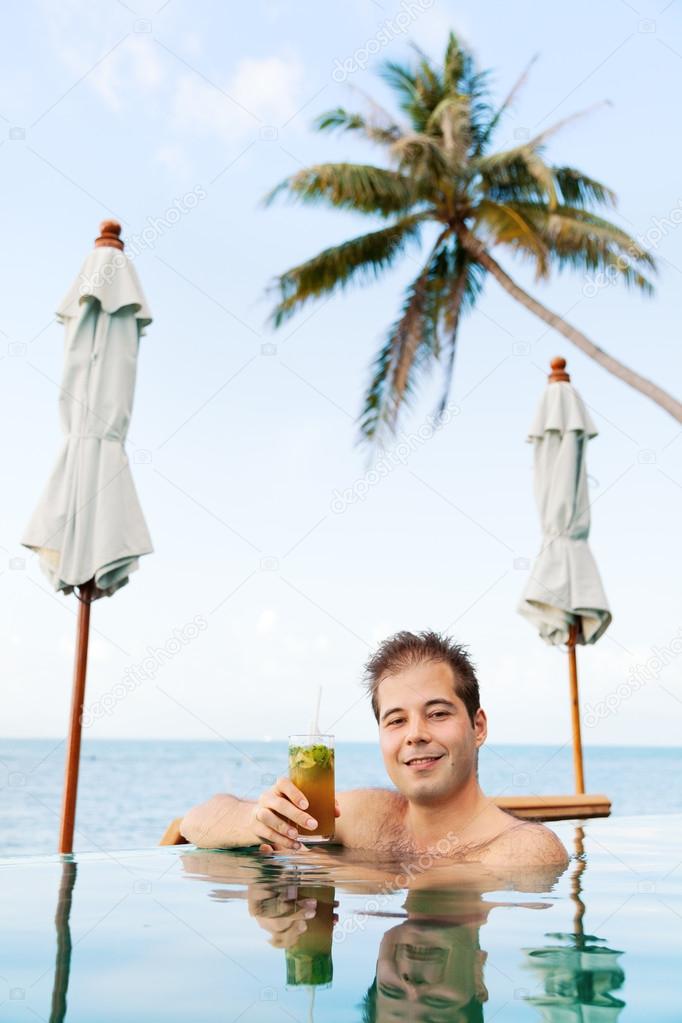 Young man drinking Mojito Cocktail