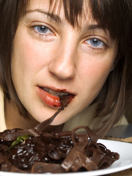 Woman with chocolate tagliatelle — Stock Photo, Image