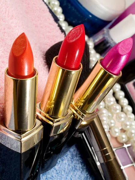 Cosmetics with lipsticks and pearl — Stock Photo, Image