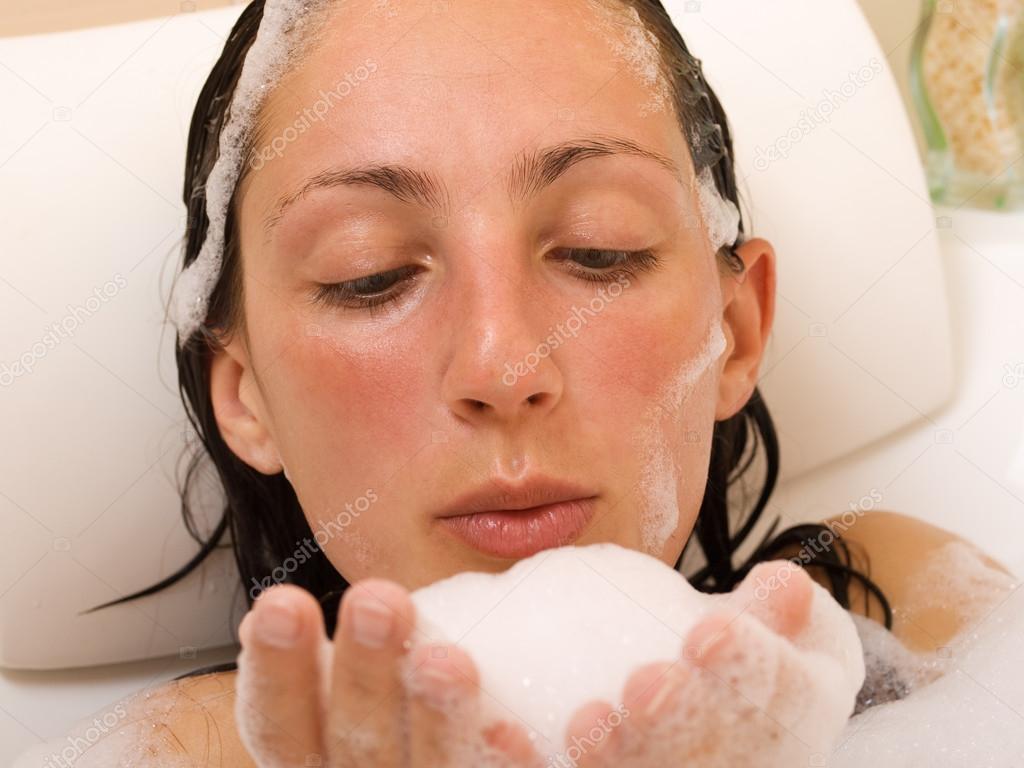 Young woman in bubble bath