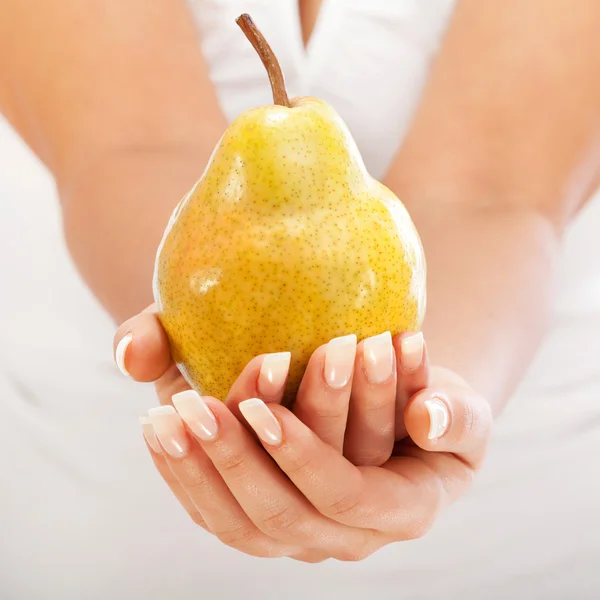Young woman holding pear — Stock Photo, Image