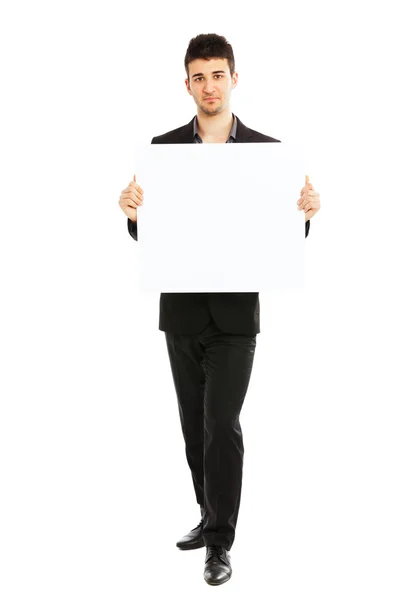 Joven empresario sosteniendo tablero en blanco — Foto de Stock