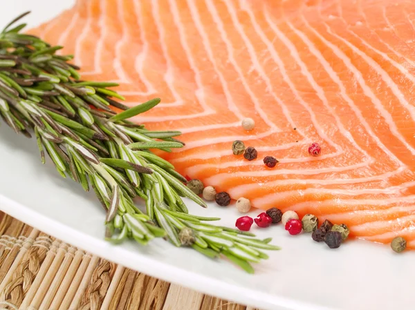 Raw salmon meat with rosemary — Stock Photo, Image