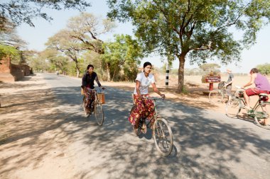 women driving bikes in Bagan