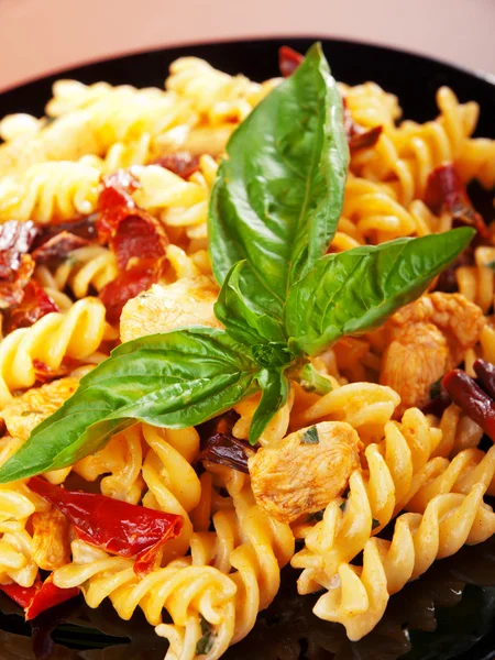 Fusilli with chicken and dried tomatoes — Stock Photo, Image