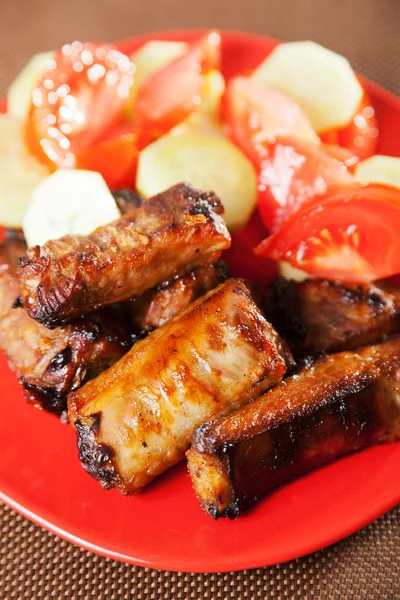 Baked pork ribs with salad — Stock Photo, Image