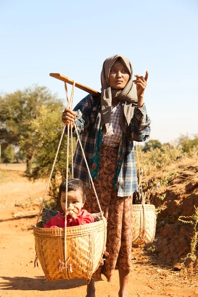 Middle aged woman carrying her child — Stock Photo, Image