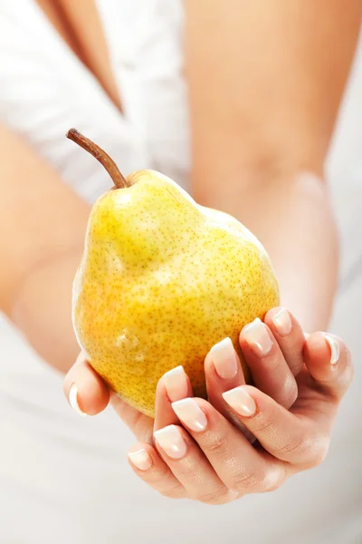 Young woman holding pear — Stock Photo, Image