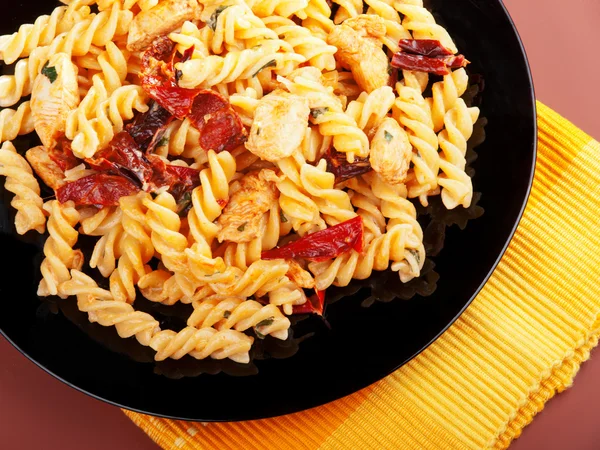 Fusilli with chicken and dried tomatoes — Stock Photo, Image