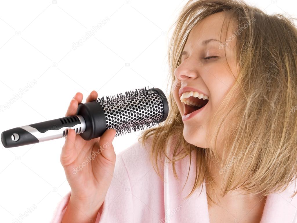 Woman singing with hairbrush