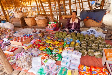 Old Burmese woman selling tobacco