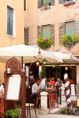 Tourists sitting in a street restaurant ,Venice