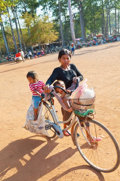 Cambodian woman driving her small child — Stock Photo, Image