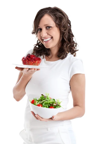 Vrouw kiezen snoepjes of gezond eten — Stockfoto